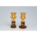 A pair of gilt bronze Medici vases on a red marble base, 20th C.