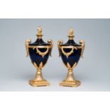 A pair of gilt brass mounted blue glass cassolettes with floral design, 20th C.