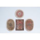 Four various Oriental rugs with floral design, wool on cotton, 20th C.