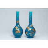 A pair of large Japanese turquoise ground gilt lacquered vases with birds among blossoming branches