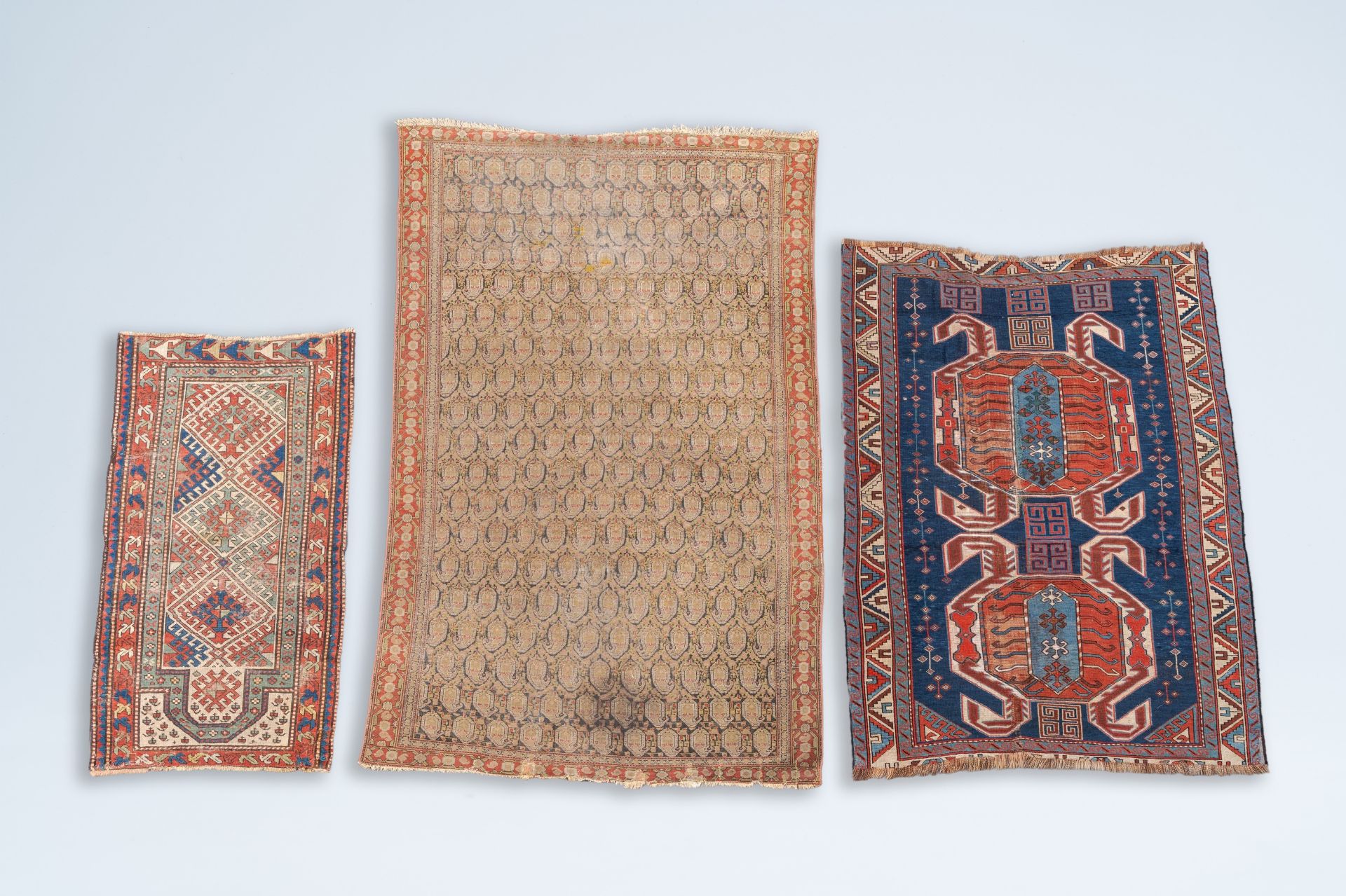 Two Caucasian carpets with geometric design and an Oriental Qom (Qum/Ghom) rug, wool on cotton, 19th