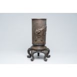 A large Japanese five-legged bronze vase with a roaring tiger in relief, Meiji, 19th C.