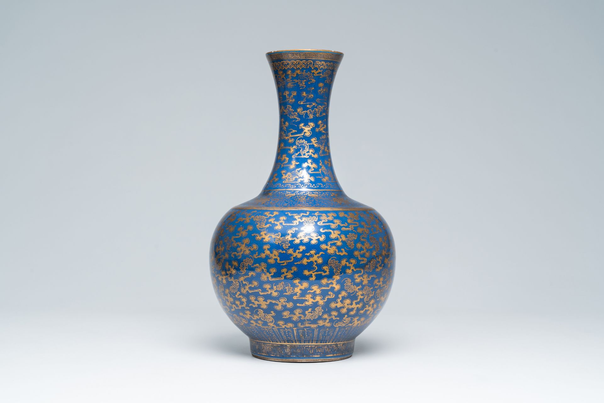 A Chinese blue ground gilt decorated 'bats amongst scrolling clouds' bottle vase, Guangxu mark and o