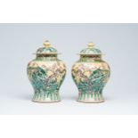 A pair of Chinese verte biscuit vases and covers with pheasants among peonies, 19th/20th C.