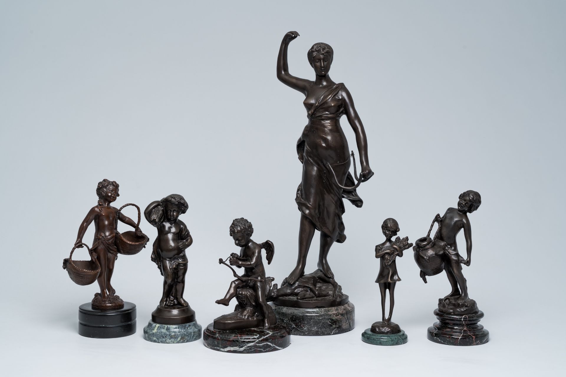 A varied collection of six French bronze sculptures on a marble base, 20th C.