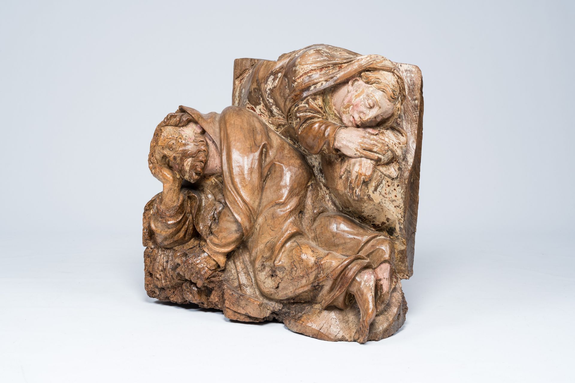 A probably German carved walnut group depicting the sleeping apostles Peter and John with remains of