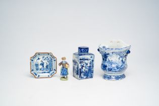 A varied collection of Dutch Delft blue and white items with figures in a landscape and a polychrome