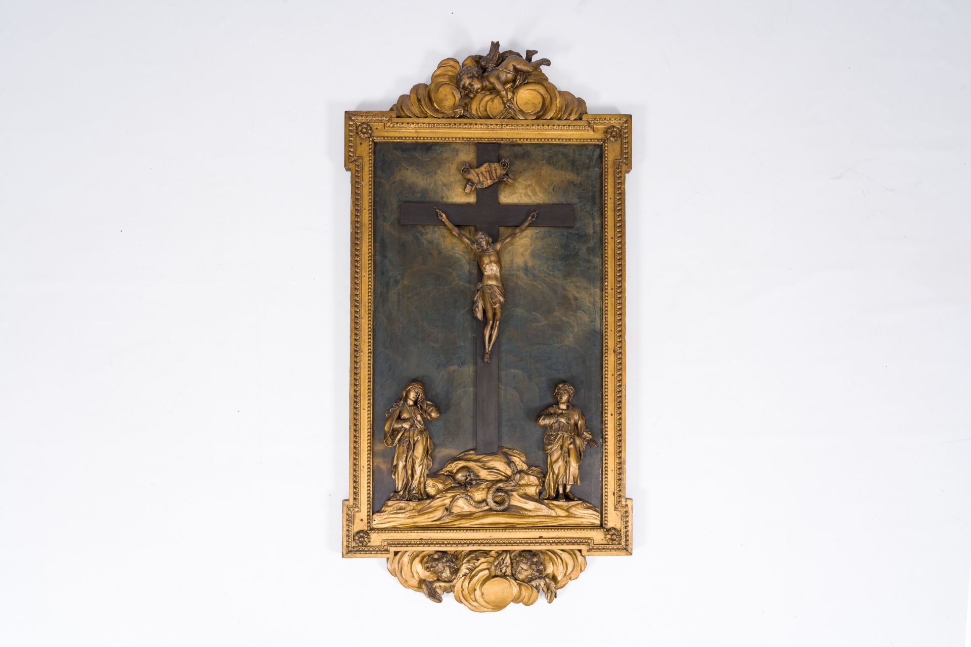 A Flemish carved and gilt wood Calvary surrounded by angels, late 18th C.