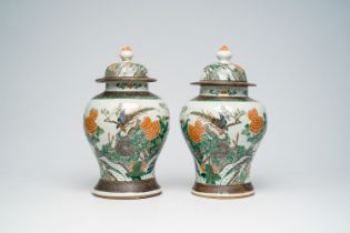 A pair of Chinese Nanking crackle glazed famille verte vases and covers with pheasants among blossom