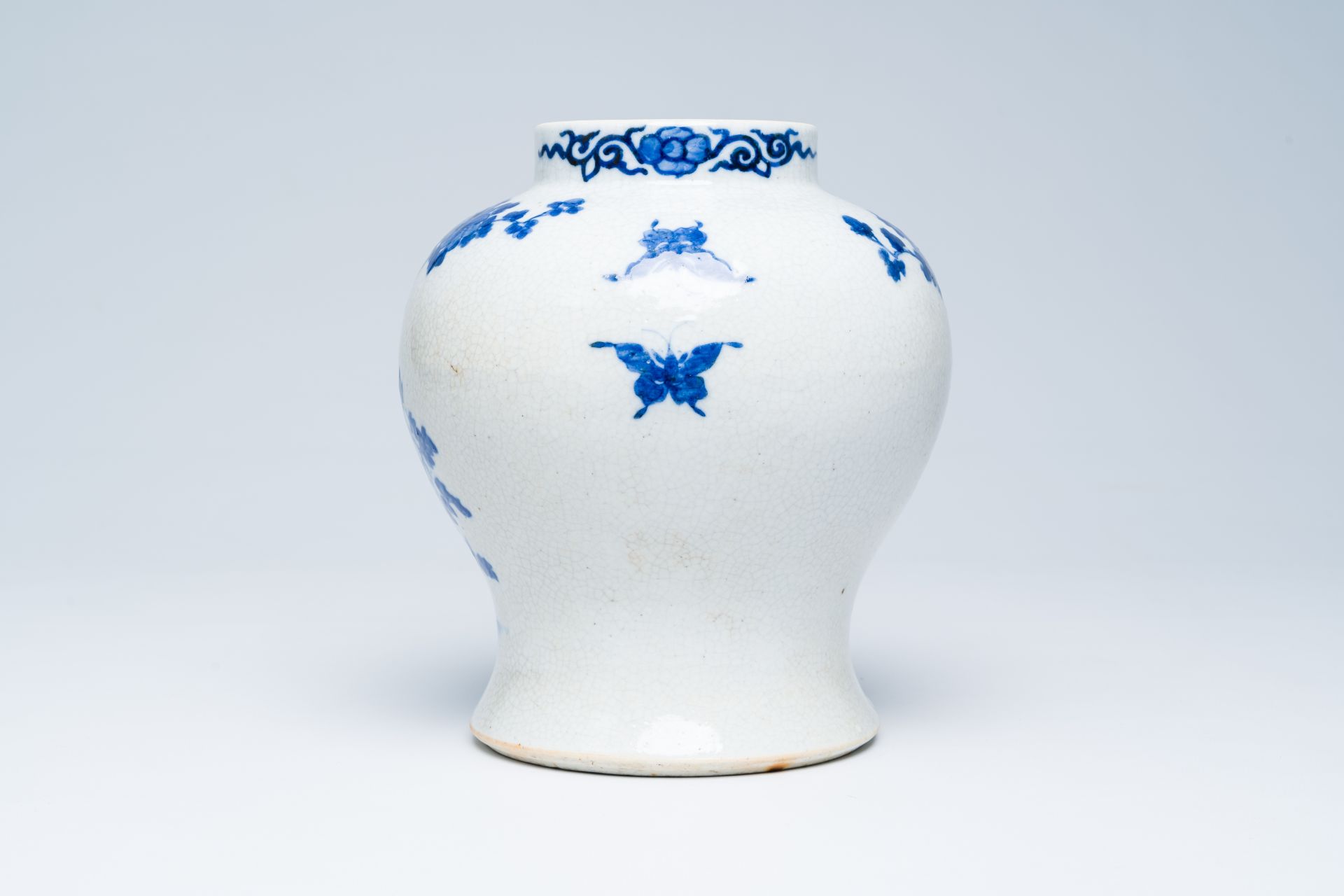 A Chinese crackle glazed blue and white vase with a bird among blossoming branches, 19th C. - Image 3 of 6