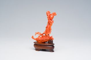 A Chinese carved red coral figure of an immortal on a boat, 19th/20th C.