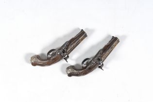 A pair of French two-barrelled silver mounted percussion pistols with walnut gunstocks and silver in