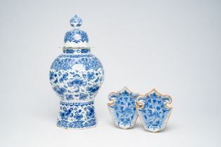 A Dutch Delft blue and white vase and cover with birds among blossoming branches and a pair of 'drag
