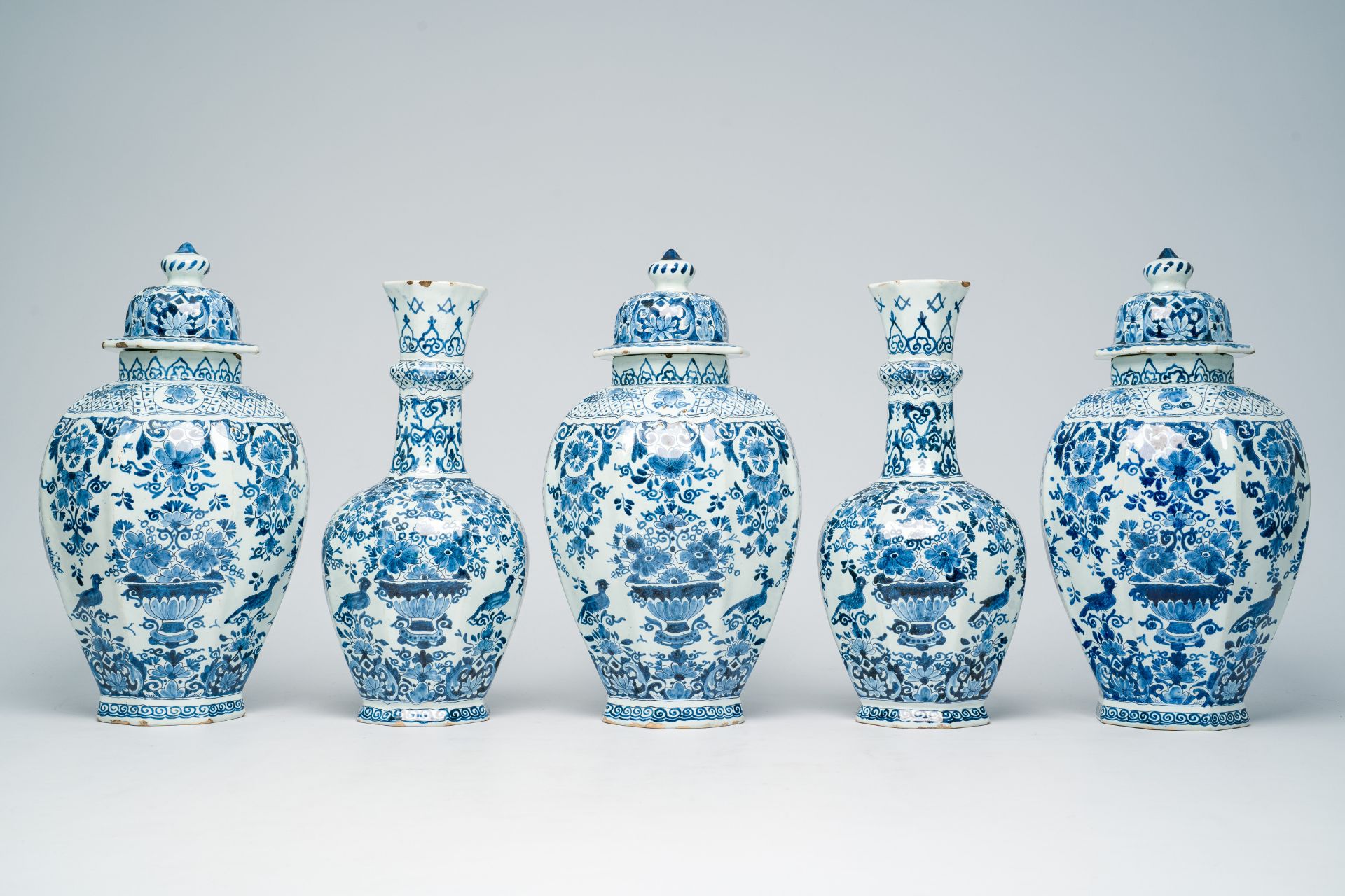A Dutch Delft blue and white five-piece vase garniture with flower baskets and birds among blossomin - Image 4 of 8