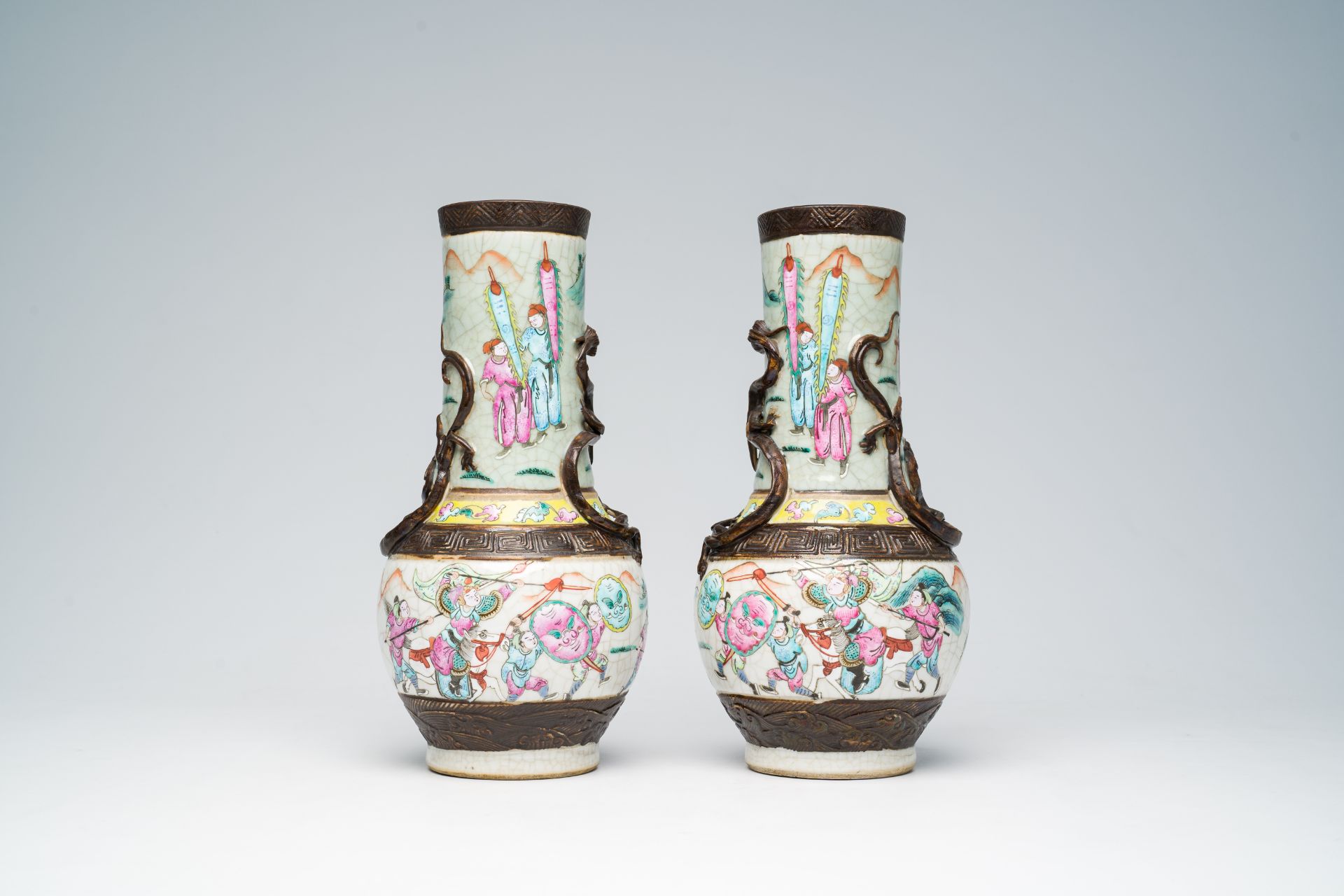 A pair of Chinese Nanking crackle glazed famille rose 'warrior' vases with dragons chasing the pearl - Image 3 of 6