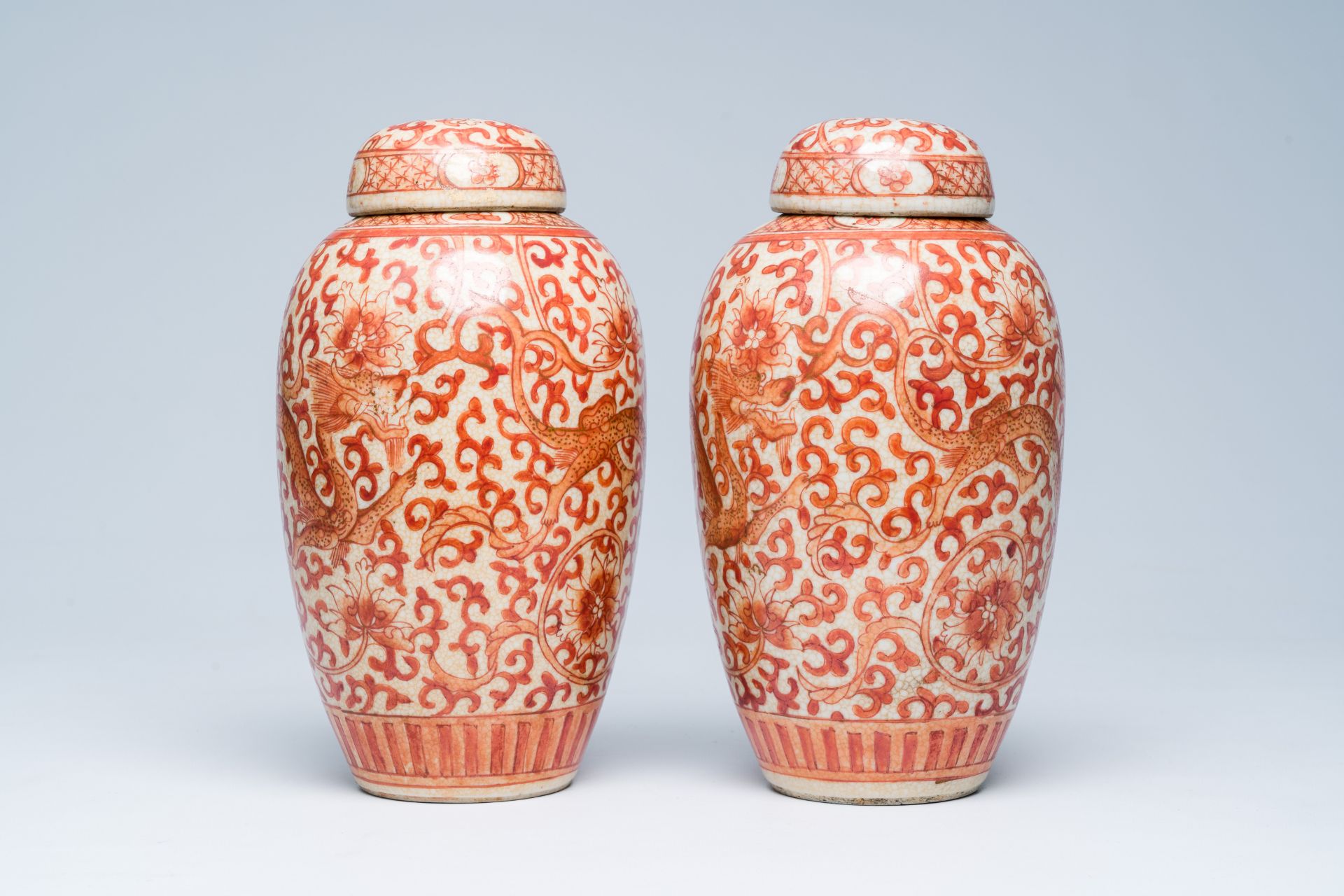 A pair of Chinese crackle glazed iron-red jars and covers with dragons among lotus scrolls, 19th C. - Image 2 of 6