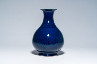 A Chinese monochrome blue vase with underglaze design, 19th/20th C.