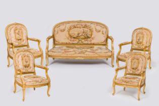 A French five-piece salon set comprising four gilt wood armchairs and a sofa with embroidered uphols