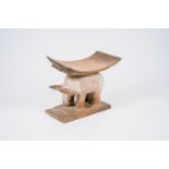 A Ghanese hardwood zoopomorphic stool with a curved seat, Fante or Ashanti, 20th C.