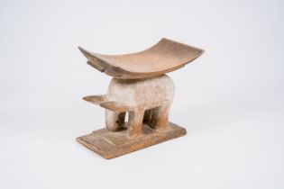 A Ghanese hardwood zoopomorphic stool with a curved seat, Fante or Ashanti, 20th C.