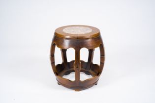 A Chinese open worked carved wood garden seat with marble top, 20th C.