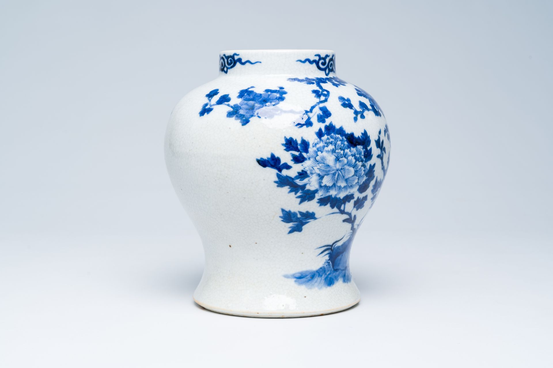 A Chinese crackle glazed blue and white vase with a bird among blossoming branches, 19th C. - Image 4 of 6