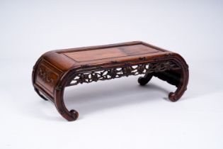 A Chinese open worked carved wood opium table, 20th C.