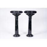 A pair of Italian black-grey marble pedestals crowned with a bowl, 20th C.
