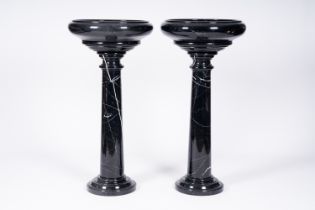 A pair of Italian black-grey marble pedestals crowned with a bowl, 20th C.