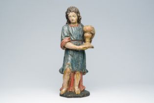 A Flemish carved and polychrome decorated figure of an angel with a candlestick in hand, 18th C.