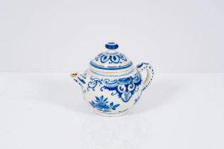A Dutch Delft blue and white teapot and cover with floral design, 18th C.