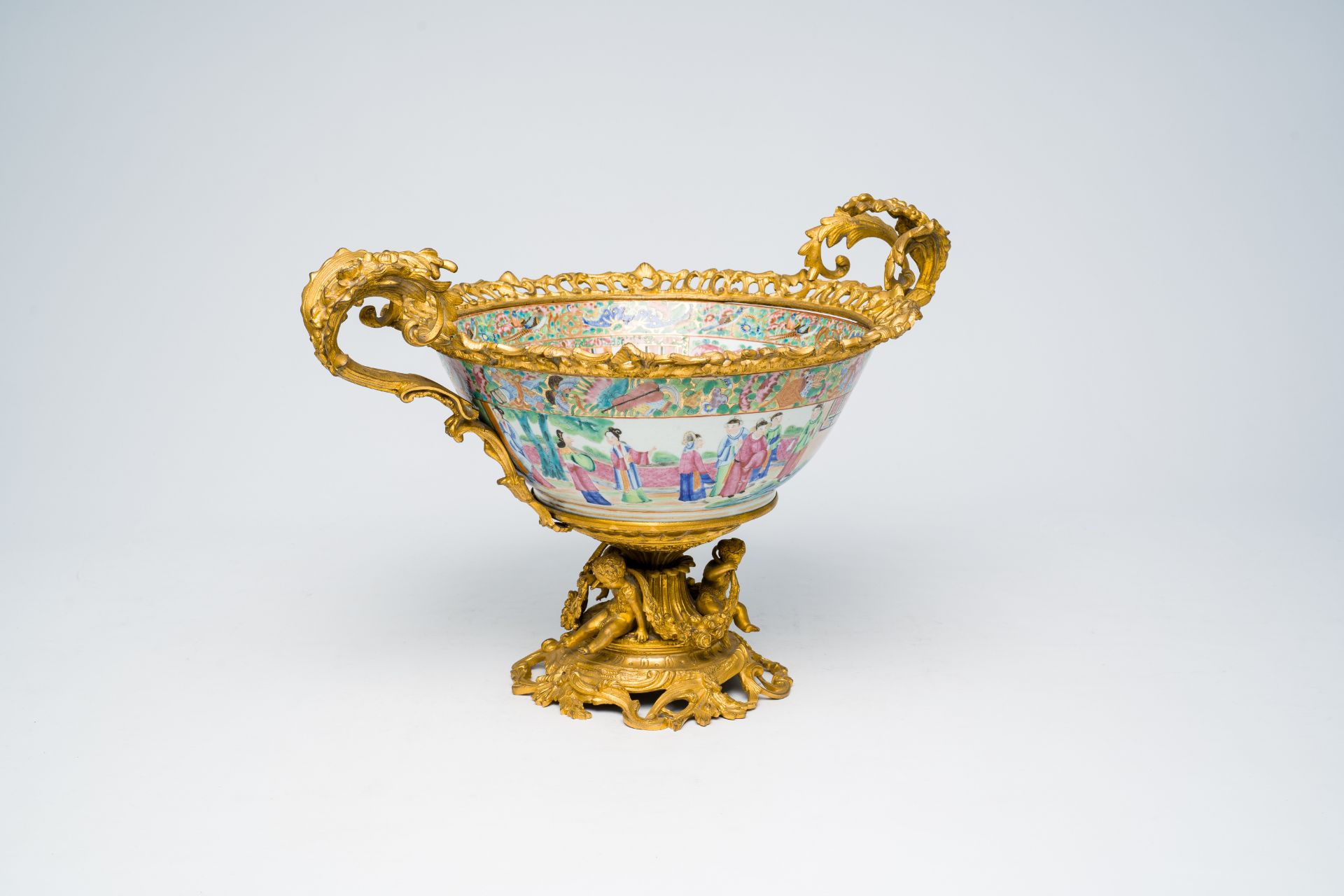 A Chinese gilt bronze mounted Canton famille rose bowl with a palace scene all around. 19th C.