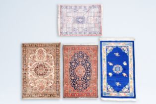 A Chinese woolen 'Beijing' rug with antiquities and three various Oriental rugs with floral design,