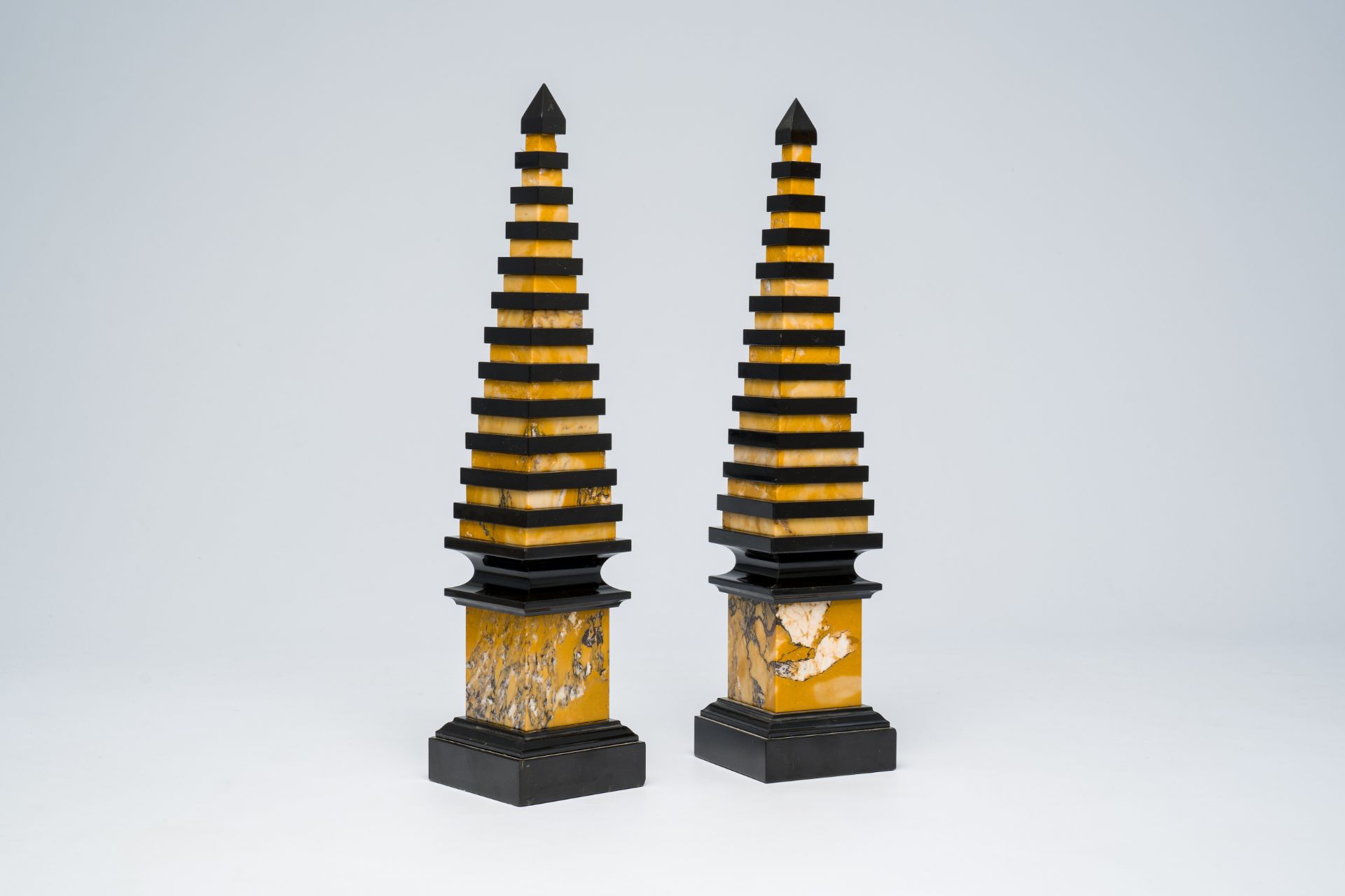 A pair of Italian Neoclassical black and yellow marble obelisks, 20th C.