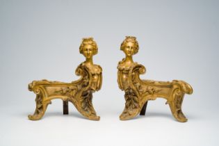 A pair of French Louis XIV style bronze andirons crowned with a regal lady's bust in the manner of F