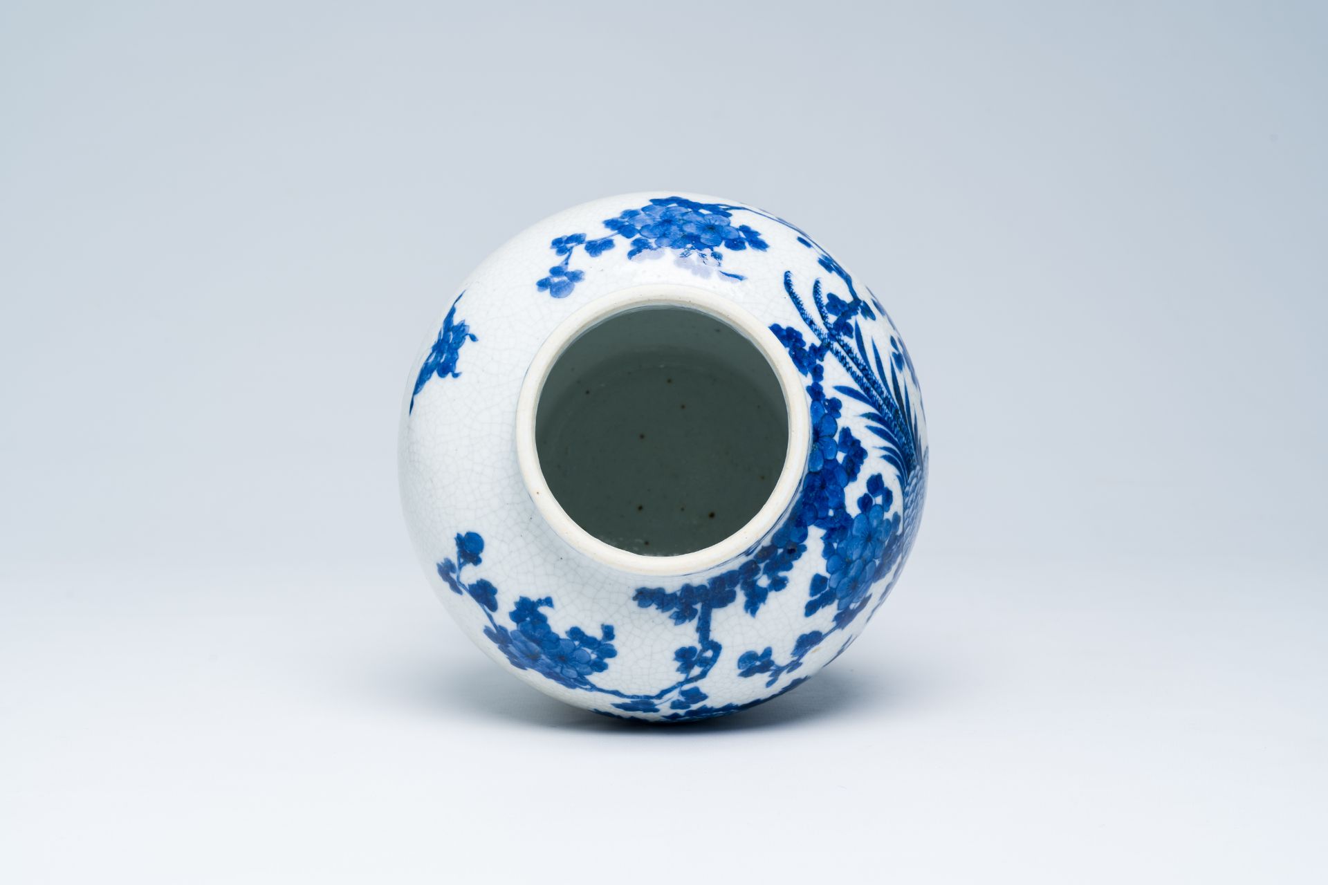A Chinese crackle glazed blue and white vase with a bird among blossoming branches, 19th C. - Image 5 of 6