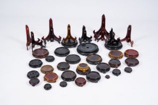 A collection of Chinese carved wood stands and plate holders, 20th C.