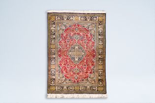 A Persian Tabriz rug with floral design, wool and silk on cotton, 20th C.