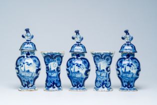 A Dutch Delft blue and white five-piece vase garniture with a fisherman in a landscape, 18th C.