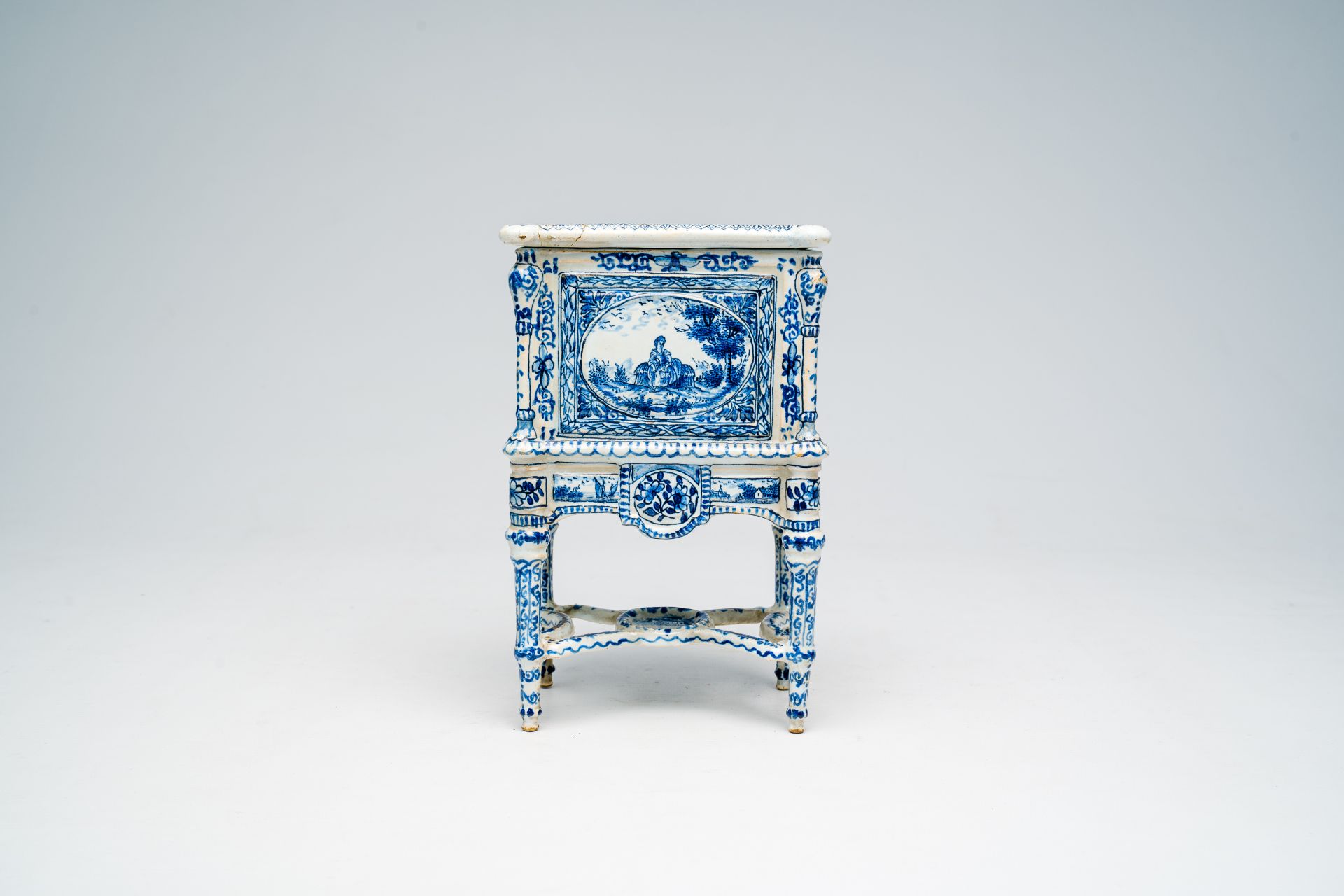 A French blue and white earthenware cabinet on stand with figures in a landscape and floral design, - Image 2 of 7