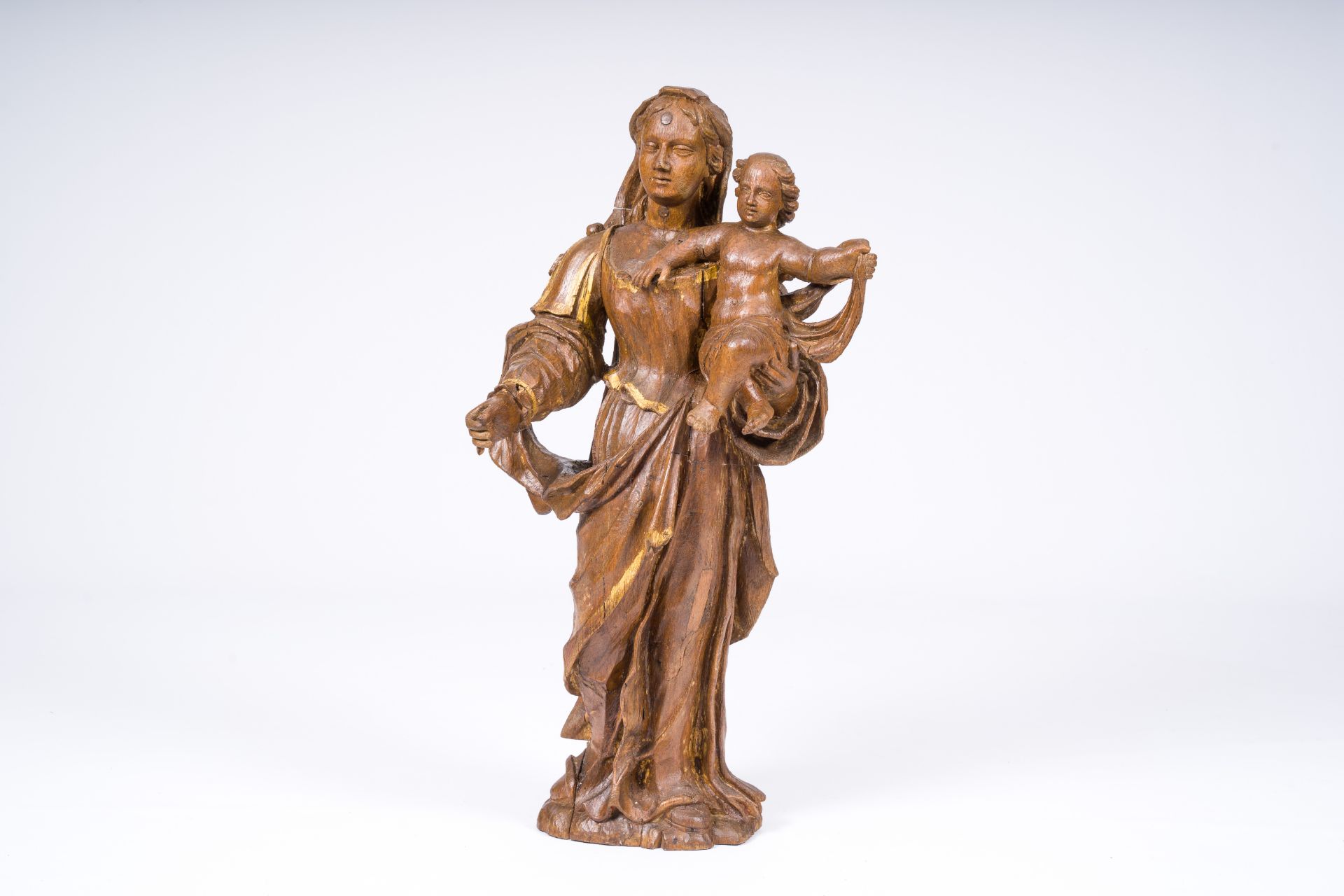A Flemish carved oak wood Virgin and Child with gilt design, 17th C.