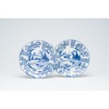 A pair of Chinese blue and white plates with a river landscape and floral design, Kangxi