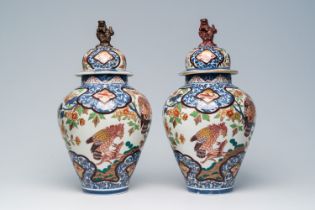 A pair of Japanese Imari 'hunting eagles' vases and covers, Meiji, 19th C.