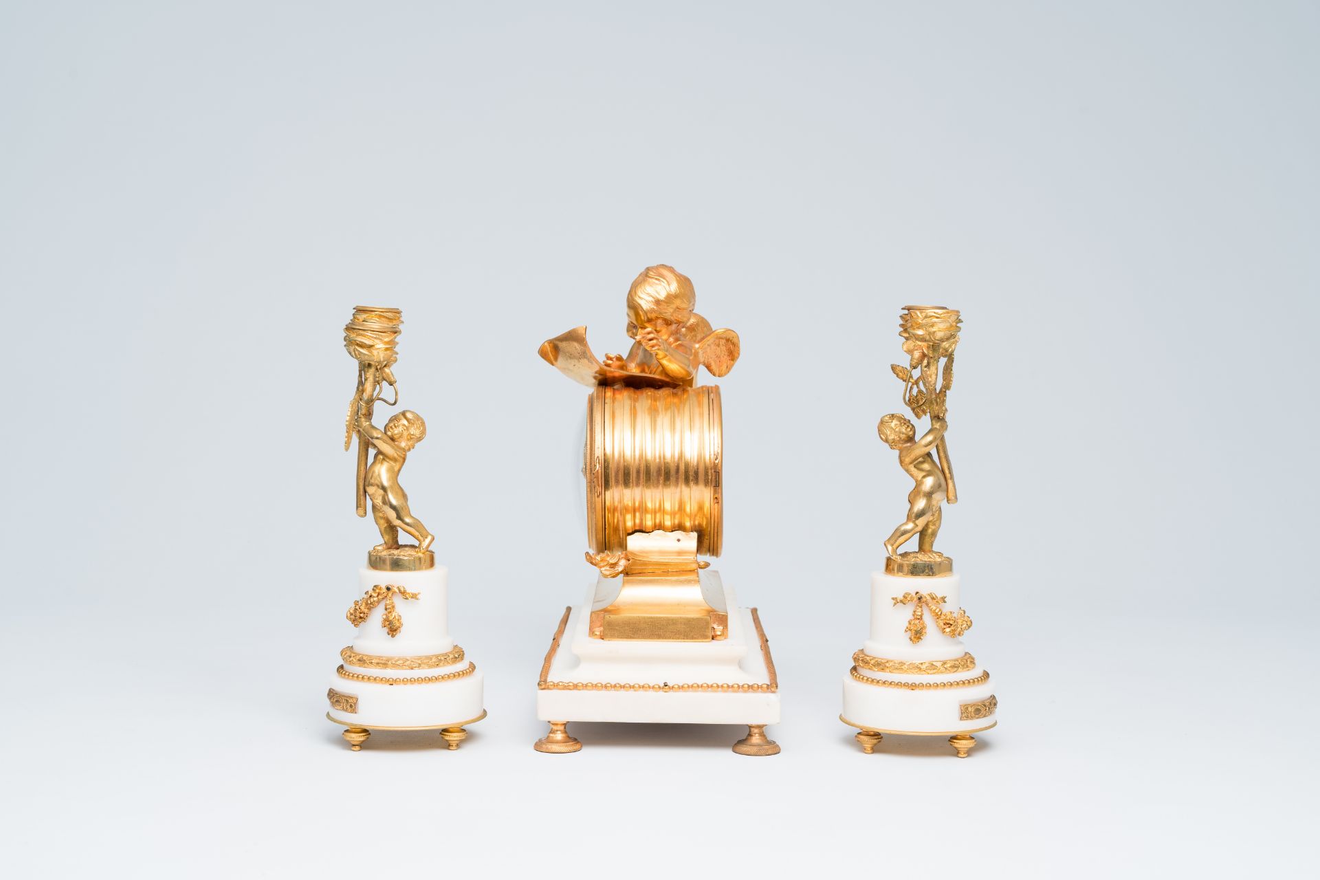 A French gilt bronze mounted white marble three-piece clock garniture with putti, 19th C. - Image 3 of 33