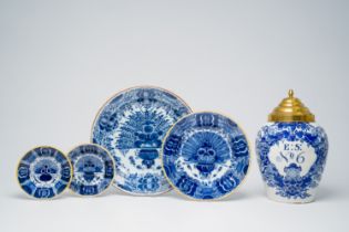 Four Dutch Delft blue and white 'peacock tail' plates and dishes and a tobacco jar, 18th C.