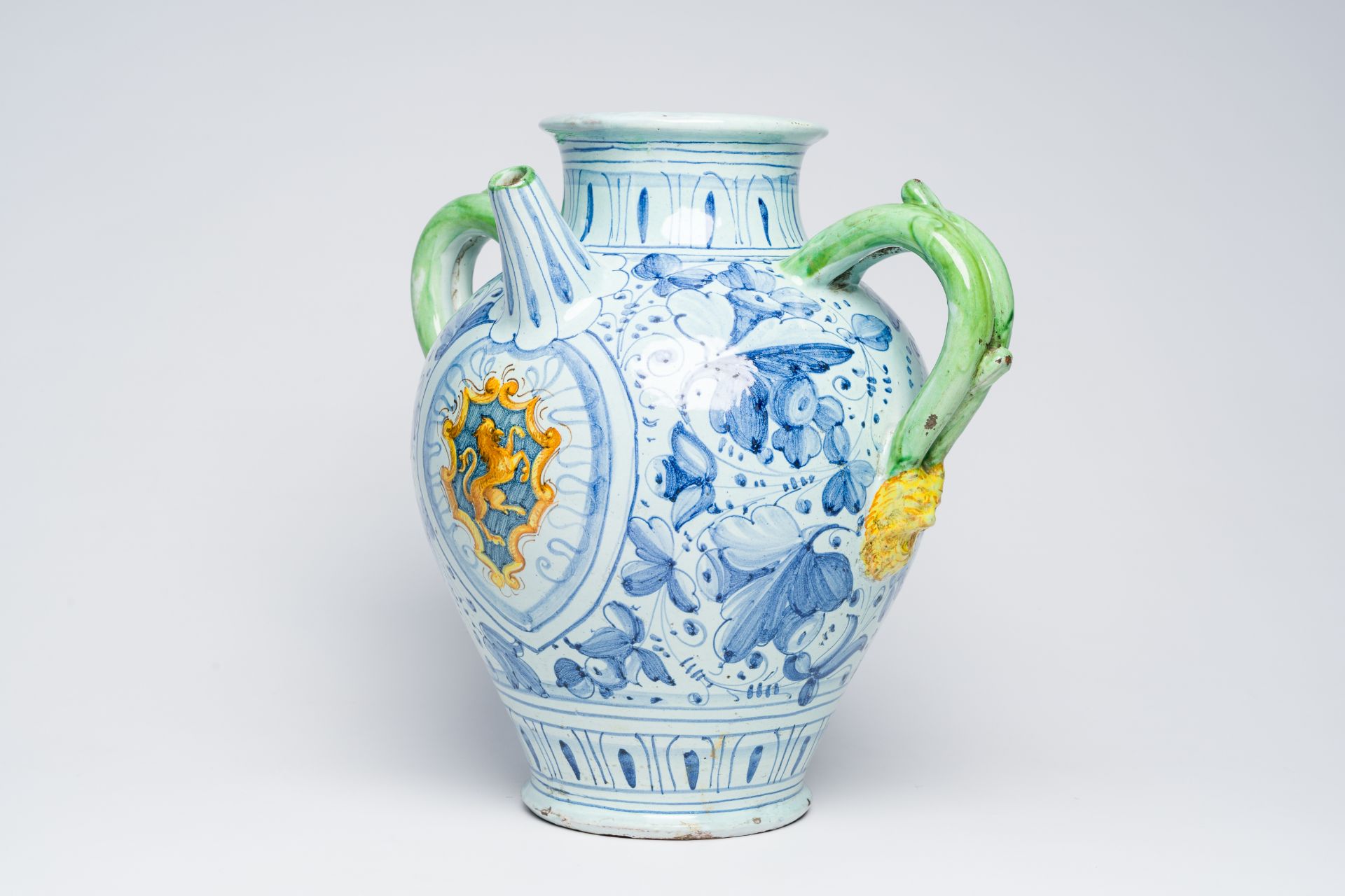 A large Italian polychrome maiolica pharmacy jar with a coat of arms and floral design, possibly 17t