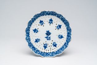 A Dutch Delft blue and white strainer with floral design, 18th C.