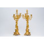 A pair of French gilt bronze five-light candlesticks with putti and floral design, 19th C.