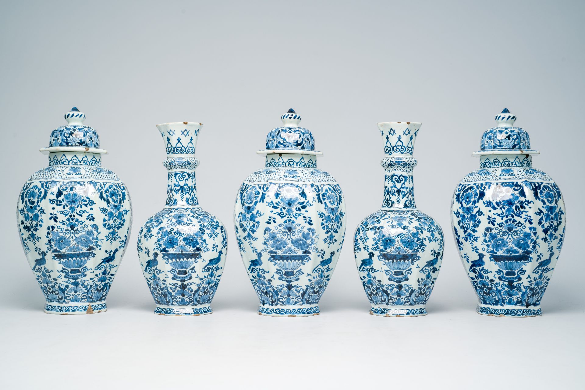 A Dutch Delft blue and white five-piece vase garniture with flower baskets and birds among blossomin - Image 2 of 8