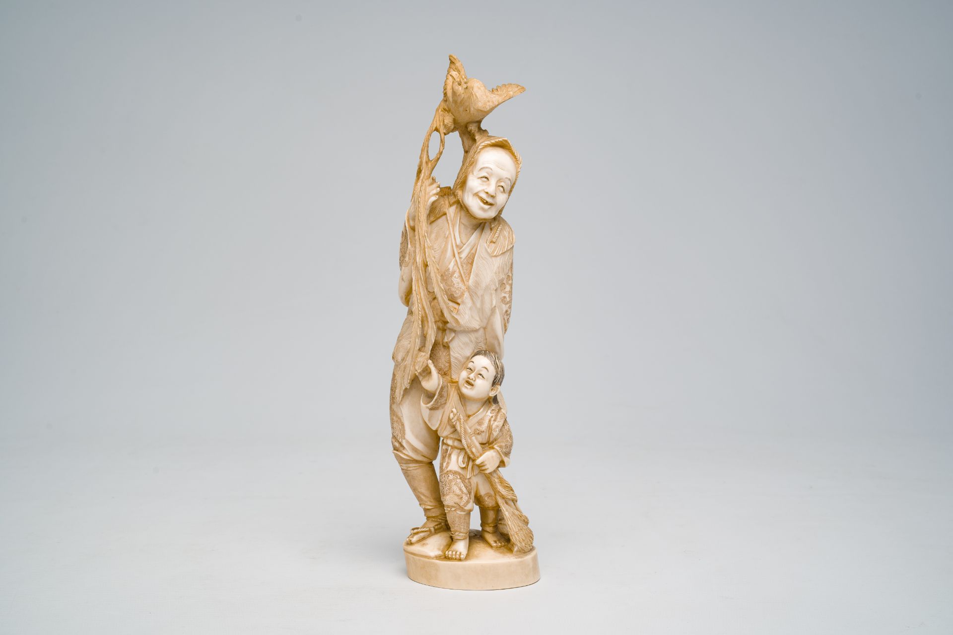A Japanese ivory okimono of a laughing man with a child and a rooster, signed, Meiji, ca. 1900 - Image 2 of 7